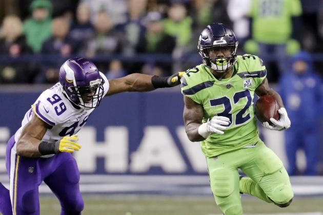 Seattle Seahawks' Chris Carson carries as Minnesota Vikings' Danielle Hunter gives chase in the first half of an NFL football game, Monday, Dec. 10, 2018, in Seattle. (AP Photo/Stephen Brashear)