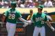 OAKLAND, CA - JULY 13: Matt Olson #28 and Matt Chapman #26 of the Oakland Athletics celebrate after they both scored on a bases loaded RBI single from Robbie Grossman #8 (not pictured) against the Chicago White Sox in the bottom of the first inning at Ring Central Coliseum on July 13, 2019 in Oakland, California. The Athletics won the game 13-2. (Photo by Thearon W. Henderson/Getty Images)