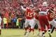 Kansas City Chiefs quarterback Patrick Mahomes (15) throws a touchdown pass to wide receiver Tyreek Hill as offensive lineman Andrew Wylie (77) blocks Arizona Cardinals defensive tackle Corey Peters (98) during the first half of an NFL football game in Kansas City, Mo., Sunday, Nov. 11, 2018. (AP Photo/Charlie Riedel)
