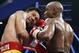 FILE - This May 2, 2015 file photo shows Manny Pacquiao from the Philippines, left, trading punches with Floyd Mayweather Jr., during their welterweight title fight in Las Vegas. A federal judge Friday, Aug. 25, 2017 dismissed class-action lawsuits by disgruntled boxing fans around the country who complained they didn't get their pay-per-view money's worth in the fight. The judge said that he felt sympathy for fans who felt deceived that Pacquiao's camp failed to disclose he had a shoulder injury until about three hours before the fight. (AP Photo/John Locher, File)