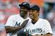 Baseball Hall of Fame players, outfielder Andre Dawson, left, and Tony Perez, pose after Dawson threw out the ceremonial first pitch before a baseball game between the Florida Marlins and the Los Angeles Dodgers, Friday, April 9, 2010, in Miami. (AP Photo/Wilfredo Lee)