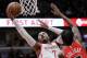 Houston Rockets forward Carmelo Anthony, left, drives to the basket against Chicago Bulls forward Justin Holiday during the first half of an NBA basketball game Saturday, Nov. 3, 2018, in Chicago. (AP Photo/Nam Y. Huh)