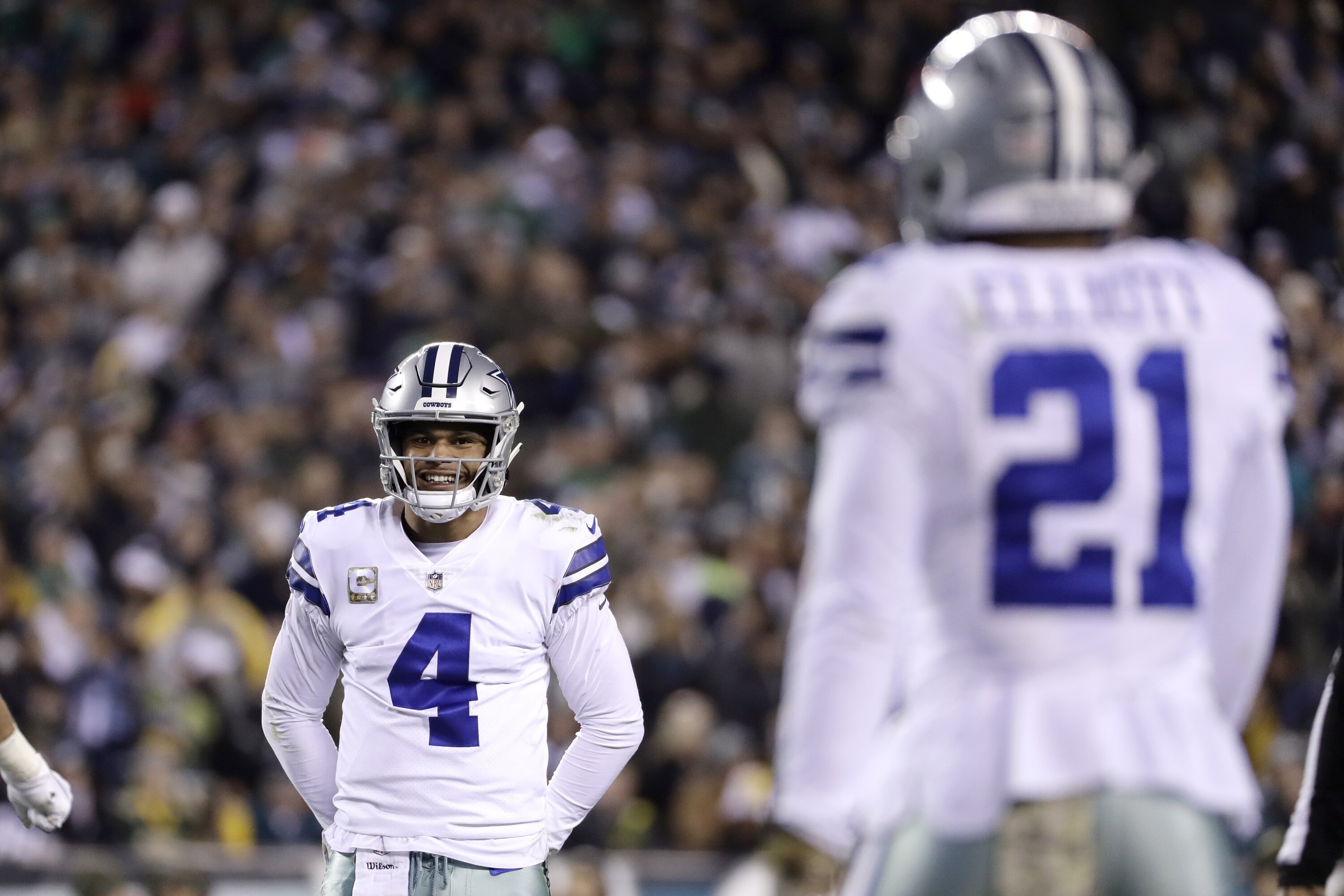 Dallas Cowboys quarterback Dak Prescott, left, looks in the direction of running back Ezekiel Elliott (21) during the first half of an NFL football game against the Philadelphia Eagles, Sunday, Nov. 11, 2018, in Philadelphia. (AP Photo/Matt Slocum)