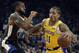 Los Angeles Lakers' Michael Beasley, right, drives the ball against Golden State Warriors' Andre Iguodala (9) in the first half of an NBA basketball game Saturday, Feb. 2, 2019, in Oakland, Calif. (AP Photo/Ben Margot)
