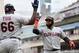 MINNEAPOLIS, MN - AUGUST 11: Yasiel Puig #66 of the Cleveland Indians congratulates teammate Carlos Santana #41 on a grand slam against the Minnesota Twins during the tenth inning of the game on August 11, 2019 at Target Field in Minneapolis, Minnesota. The Indians defeated the Twins 7-3 in ten innings. (Photo by Hannah Foslien/Getty Images)