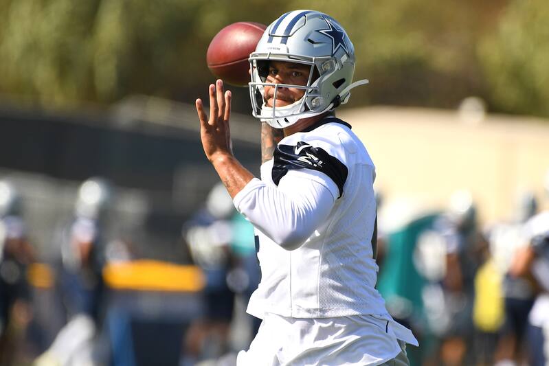 OXNARD, CA - JULY 28: Quarterback Dak Prescott #4 of the Dallas Cowboys looks to make a pass during training camp drills on July 28, 2019 in Oxnard, California. (Photo by Jayne Kamin-Oncea/Getty Images)