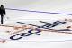 Philip Westmoreland throws water on the Washington Capitals logo at center ice as the logos are placed and the lines painted in preparation for the upcoming NHL hockey season at Verizon Center, Wednesday, Jan. 9, 2013, in Washington. (AP Photo/Alex Brandon)