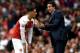 LONDON, ENGLAND - AUGUST 12: Unai Emery, Manager of Arsenal speaks with Mesut Ozil of Arsenal during the Premier League match between Arsenal FC and Manchester City at Emirates Stadium on August 12, 2018 in London, United Kingdom. (Photo by Shaun Botterill/Getty Images)
