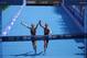 Britain's Georgia Taylor-Brown, left, and Jessica Learmonth hold hands as they cross the finish line during a women's triathlon test event at Odaiba Marine Park, a venue for marathon swimming and triathlon at the Tokyo 2020 Olympics, Thursday, Aug. 15, 2019, in Tokyo. (AP Photo/Jae C. Hong)