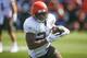 Cleveland Browns running back Nick Chubb (24) runs through a drill during practice at the NFL football team's training facility Monday, Aug. 5, 2019, in Berea, Ohio. (AP Photo/Ron Schwane)
