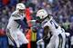 Los Angeles Chargers quarterback Philip Rivers, left, hands off to running back Melvin Gordon in the second half of an NFL wild card playoff football game against the Baltimore Ravens, Sunday, Jan. 6, 2019, in Baltimore. (AP Photo/Carolyn Kaster)