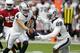 Oakland Raiders quarterback Derek Carr (4) hands off to running back Josh Jacobs (28) during the first half of an an NFL football game against the Arizona Cardinals, Thursday, Aug. 15, 2019, in Glendale, Ariz. (AP Photo/Ralph Freso)