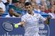 Novak Djokovic, of Serbia, returns to Pablo Carreno Busta, of Spain, during the quarterfinals of the Western & Southern Open tennis tournament Thursday, Aug. 15, 2019, in Mason, Ohio. (AP Photo/John Minchillo)
