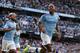 Manchester City's English midfielder Raheem Sterling (R) celebrates scoring his team's first goal during the English Premier League football match between Manchester City and Tottenham Hotspur at the Etihad Stadium in Manchester, north west England, on August 17, 2019. (Photo by Lindsey Parnaby / AFP) / RESTRICTED TO EDITORIAL USE. No use with unauthorized audio, video, data, fixture lists, club/league logos or 'live' services. Online in-match use limited to 120 images. An additional 40 images may be used in extra time. No video emulation. Social media in-match use limited to 120 images. An additional 40 images may be used in extra time. No use in betting publications, games or single club/league/player publications. / (Photo credit should read LINDSEY PARNABY/AFP/Getty Images)