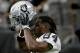 Oakland Raiders wide receiver Antonio Brown (84) puts on his helmet prior to an NFL football game against the Arizona Cardinals, Thursday, Aug. 15, 2019, in Glendale, Ariz. (AP Photo/Rick Scuteri)