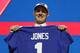 Duke quarterback Daniel Jones poses with his new jersey after the New York Giants selected Jones in the first round at the NFL football draft, Thursday, April 25, 2019, in Nashville, Tenn. (AP Photo/Mark Humphrey)