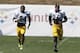 Pittsburgh Steelers wide receiver Antonio Brown (84) and running back Le'Veon Bell (26) run during practice at NFL football training camp in Latrobe, Pa. on Saturday, Aug. 1, 2015 . (AP Photo/Keith Srakocic)