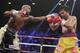 Floyd Mayweather Jr., left, stops Manny Pacquiao, from the Philippines, with a left during their welterweight title fight on Saturday, May 2, 2015 in Las Vegas. (AP Photo/Isaac Brekken)