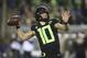 File-This Nov. 17, 2018, file photo shows Oregon quarterback Justin Herbert throwing down field against Arizona State during the first quarter of an NCAA college football game in Eugene, Ore. Herbert says he’ll return for his senior season. Herbert announced his decision on Wednesday, Dec. 26, 2018, before the Oregon left Eugene for the Redbox Bowl. Oregon plays Michigan State on Monday. (AP Photo/Chris Pietsch, File)