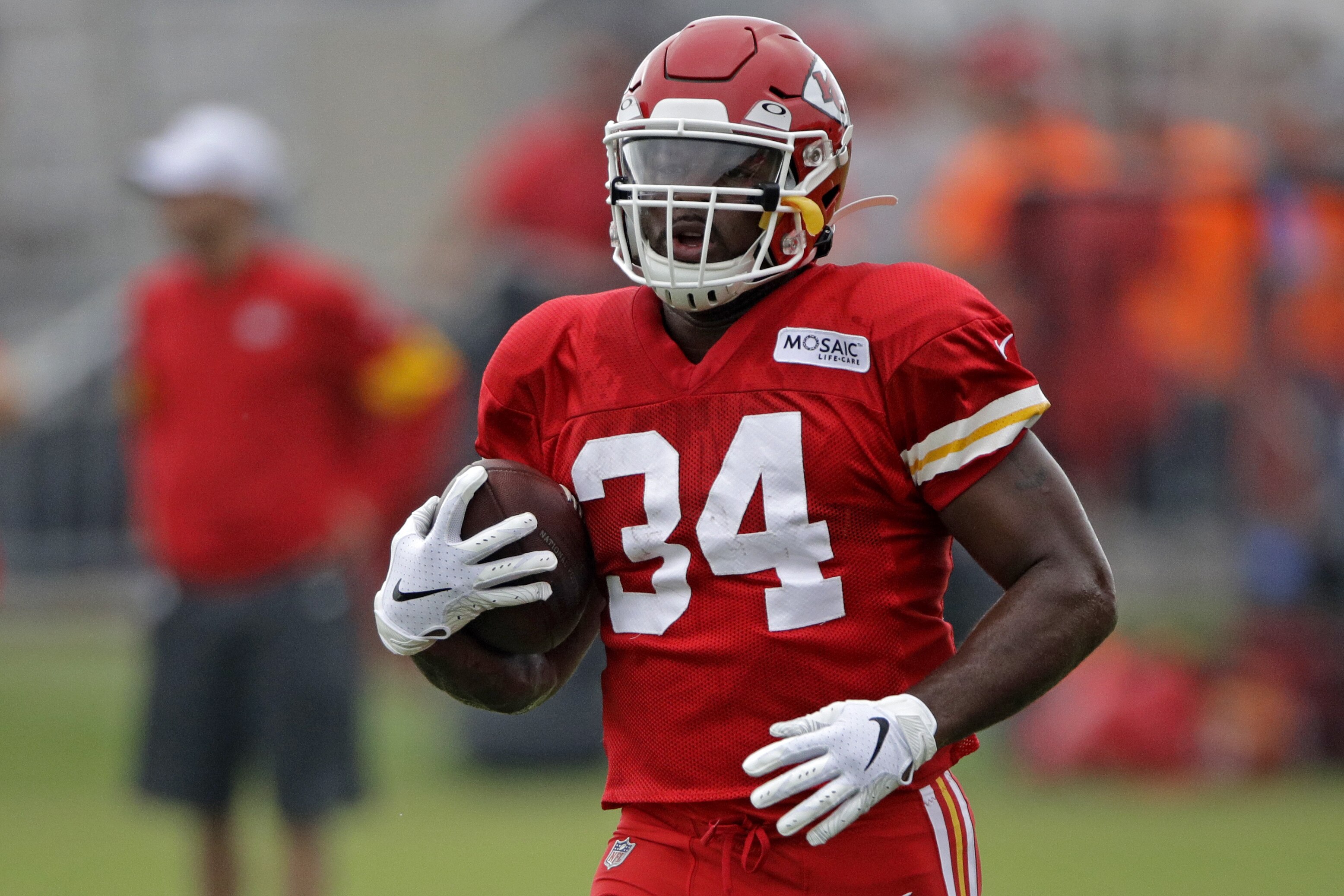 Kansas City Chiefs running back Carlos Hyde runs during NFL football training camp Monday, July 29, 2019, in St. Joseph, Mo. (AP Photo/Charlie Riedel)