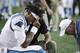 Carolina Panthers quarterback Cam Newton (1) receives attention on the sideline after an injury in the first half of an NFL preseason football game against the New England Patriots, Thursday, Aug. 22, 2019, in Foxborough, Mass. (AP Photo/Charles Krupa)