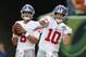 New York Giants quarterback Eli Manning (10) practices alongside quarterback Daniel Jones, left, before an NFL preseason football game, Thursday, Aug. 22, 2019, in Cincinnati. (AP Photo/Gary Landers)