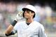 MILWAUKEE, WISCONSIN - AUGUST 25: Christian Yelich #22 of the Milwaukee Brewers walks off the field during a game against the Arizona Diamondbacks at Miller Park on August 25, 2019 in Milwaukee, Wisconsin. Teams are wearing special color schemed uniforms with players choosing nicknames to display for Players Weekend. (Photo by Stacy Revere/Getty Images)