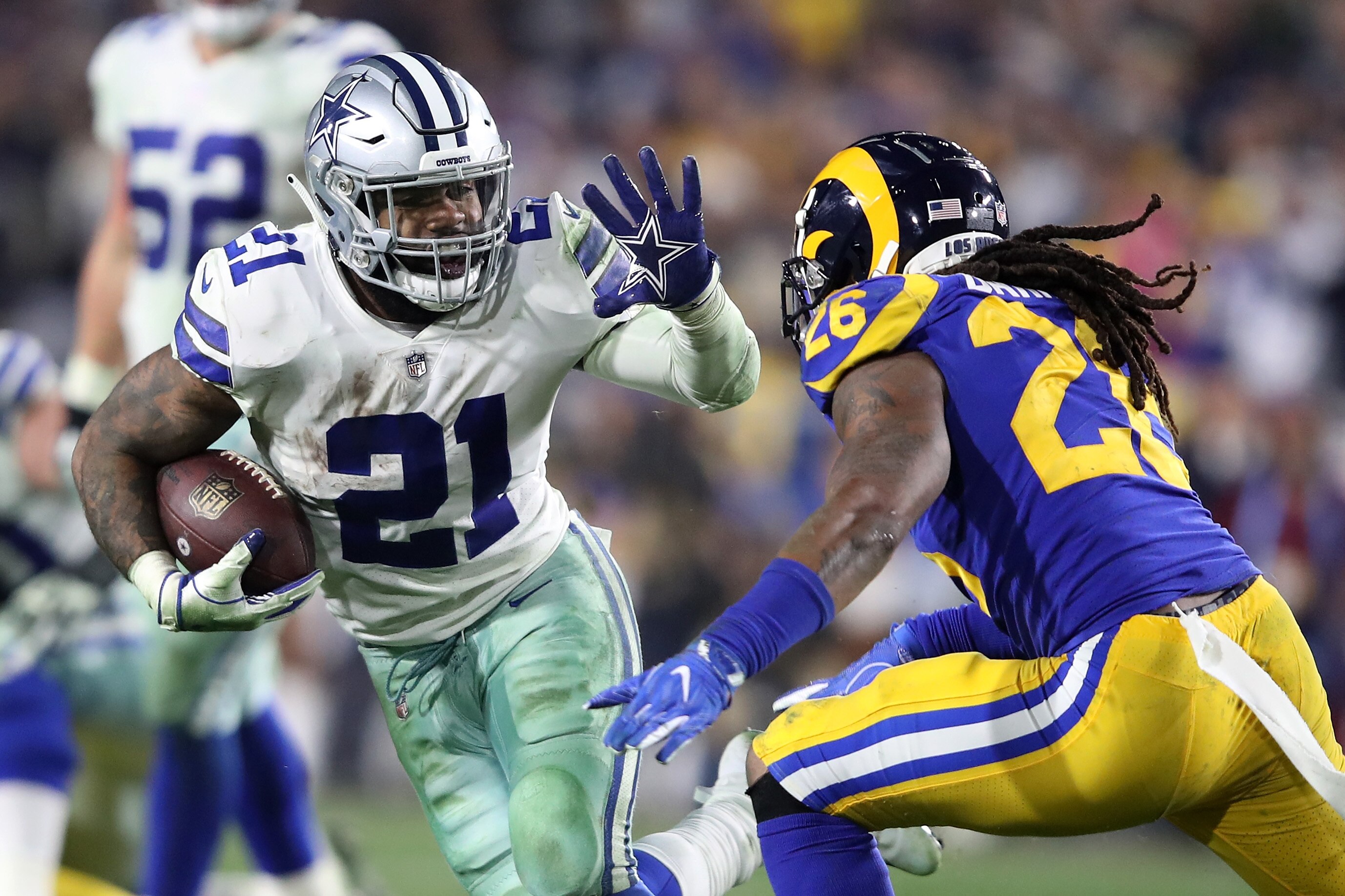 LOS ANGELES, CA - JANUARY 12: Ezekiel Elliott #21 of the Dallas Cowboys runs with the ball against Mark Barron #26 of the Los Angeles Rams in the fourth quarter in the NFC Divisional Playoff game at Los Angeles Memorial Coliseum on January 12, 2019 in Los Angeles, California.  (Photo by Sean M. Haffey/Getty Images)