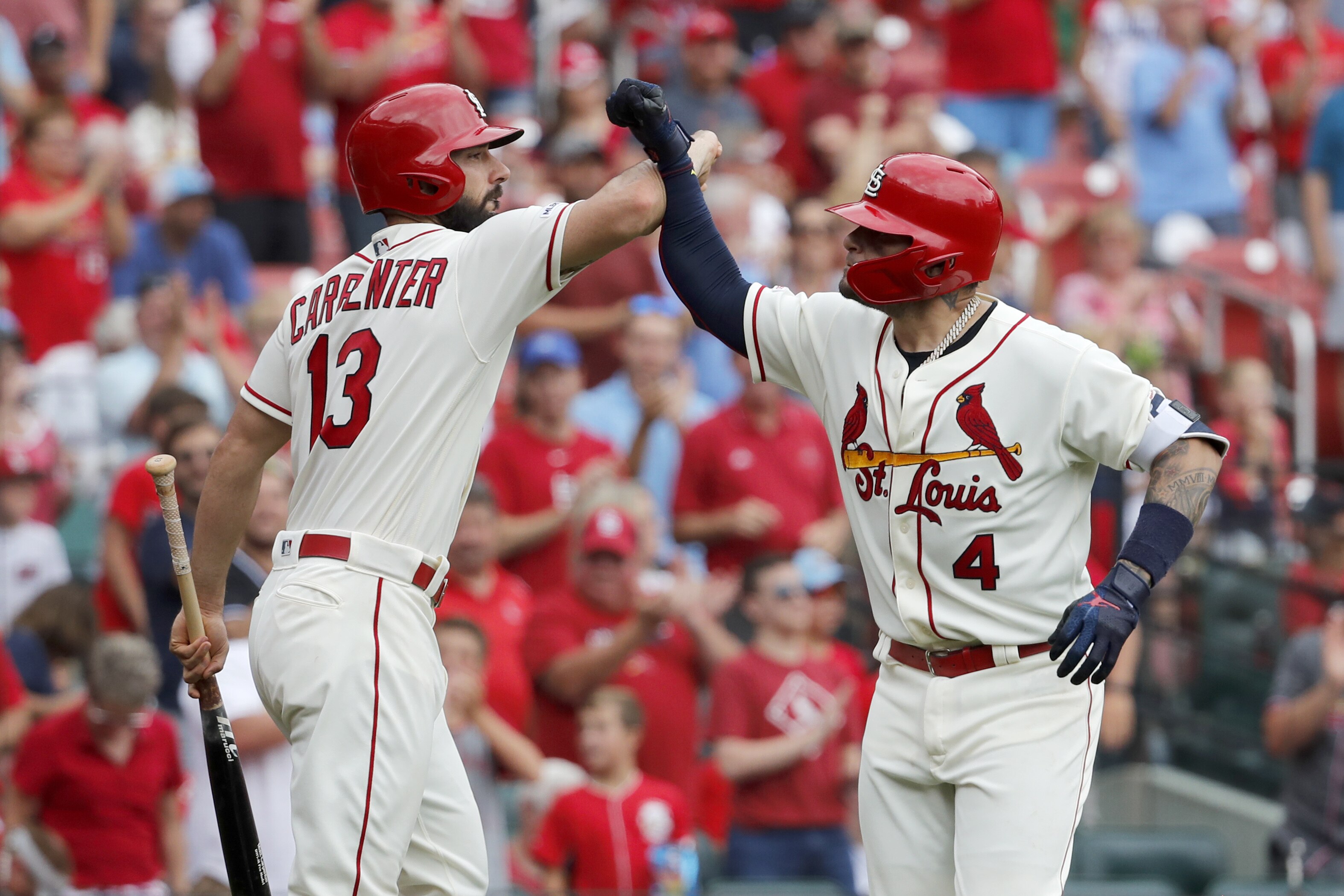 St. Louis Cardinals' Yadier Molina (4) is congratulated by teammate Matt Carpenter (13) after hitting a solo home run during the third inning in the first baseball game of a doubleheader against the Cincinnati Reds, Saturday, Aug. 31, 2019, in St. Louis. (AP Photo/Jeff Roberson)