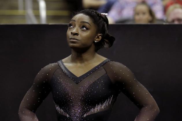 Simone Biles looks at the score during the senior women's competition at the 2019 U.S. Gymnastics Championships Sunday, Aug. 11, 2019, in Kansas City, Mo. (AP Photo/Charlie Riedel)