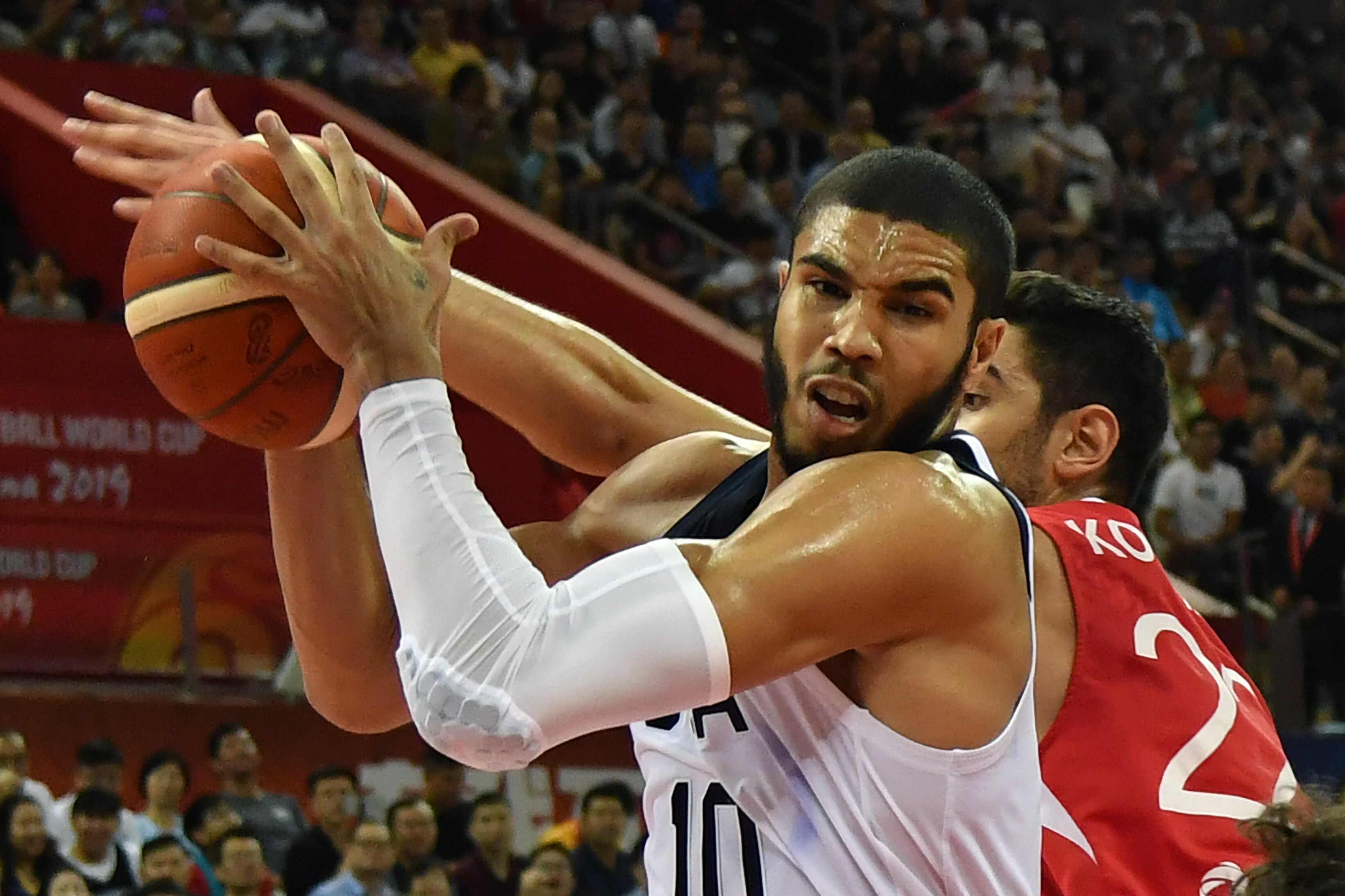 Jayson Tatum (front) of the US holds onto the ball as Turkey's Furkan Korkmaz reaches for it during the Basketball World Cup Group E game between US and Turkey in Shanghai on September 3, 2019. (Photo by HECTOR RETAMAL / AFP)        (Photo credit should read HECTOR RETAMAL/AFP/Getty Images)