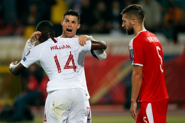 Portugal's Cristiano Ronaldo (2ndL) celebrates a goal with his teammate William Carvalho (L) during the Euro 2020 football qualification match between Serbia and Portugal in Belgrade, on September 7, 2019. (Photo by PEDJA MILOSAVLJEVIC / AFP)        (Photo credit should read PEDJA MILOSAVLJEVIC/AFP/Getty Images)