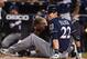 MIAMI, FLORIDA - SEPTEMBER 10: Christian Yelich #22 of the Milwaukee Brewers is checked out by the medical staff after an injury from ball deflection in the first inning against the Miami Marlins at Marlins Park on September 10, 2019 in Miami, Florida. (Photo by Mark Brown/Getty Images)