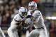 Kansas quarterback Carter Stanley (9) hands off to running back Pooka Williams Jr. (1) during the first half of an NCAA college football game in Boston, Friday, Sept. 13, 2019. (AP Photo/Michael Dwyer)