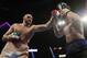 Tyson Fury, left, of England, punches Otto Wallin, of Sweden, during their heavyweight boxing match Saturday, Sept. 14, 2019, in Las Vegas. (AP Photo/Isaac Brekken)