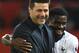 Tottenham Hotspur's Ivorian defender Serge Aurier (R) hugs Tottenham Hotspur's Argentinian head coach Mauricio Pochettino (L) at the end of the English Premier League football match between Manchester United and Tottenham Hotspur at Old Trafford in Manchester, north west England, on August 27, 2018. (Photo by Oli SCARFF / AFP) / RESTRICTED TO EDITORIAL USE. No use with unauthorized audio, video, data, fixture lists, club/league logos or 'live' services. Online in-match use limited to 120 images. An additional 40 images may be used in extra time. No video emulation. Social media in-match use limited to 120 images. An additional 40 images may be used in extra time. No use in betting publications, games or single club/league/player publications. / (Photo credit should read OLI SCARFF/AFP/Getty Images)