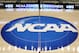 FILE - In this March 18, 2015, file photo, the NCAA logo is at center court as work continues at The Consol Energy Center in Pittsburgh, for the NCAA college basketball second and third round games. The NCAA is moving toward reforming transfer rules. There is much work to be done and any drastic changes are likely a few years away. New transfer rules will be rooted in academics, and could give higher achieving students more freedom while limiting who might be less likely to graduate if they switch schools.(AP Photo/Keith Srakocic, File)
