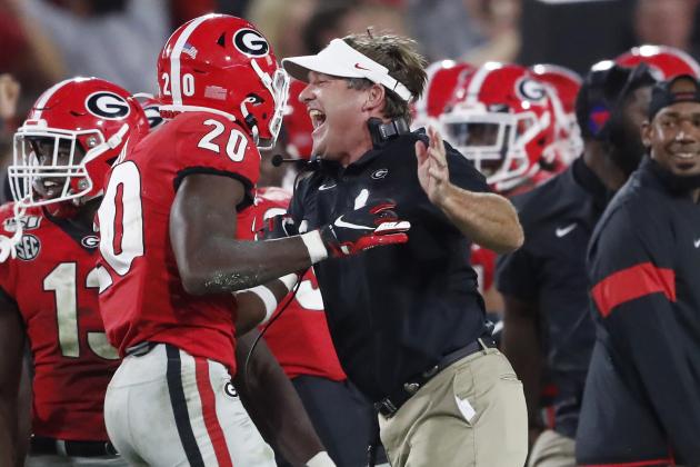 Georgia head coach Kirby Smart celebrates a Georgia interception with defensive back J.R. Reed during the second half of an NCAA college football game, Saturday, Sept. 21, 2019, in Athens, Ga. Georgia won 23-17. (AP Photo/John Bazemore)