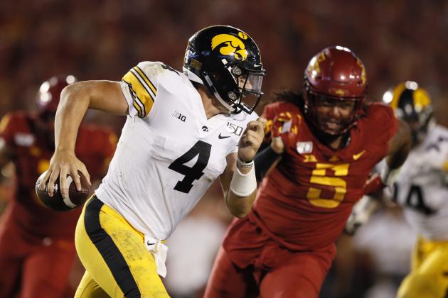 Iowa quarterback Nate Stanley runs from Iowa State defensive end Eyioma Uwazurike, right, during the second half of an NCAA college football game, Saturday, Sept. 14, 2019, in Ames, Iowa. Iowa won 18-17. (AP Photo/Charlie Neibergall)