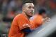 Houston Astros' Carlos Correa watches from the dugout during the eighth inning of a baseball game against the Boston Red Sox Friday, May 24, 2019, in Houston. (AP Photo/David J. Phillip)