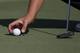 Sebastian Munoz, of Colombia, gently places his ball on the 16th green during the third round of the Sanderson Farms Championship golf tournament in Jackson, Miss., Saturday, Sept. 21, 2019. (AP Photo/Rogelio V. Solis)