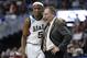 FILE - In this March 29, 2019, file photo, Michigan State guard Cassius Winston (5) puts his arm around coach Tom Izzo following the team's 80-63 win over LSU in an NCAA men's college basketball tournament East Region semifinal, in Washington. Winston has joined a select group of players in program history as an All-America player and Big Ten player of the year. If he can help the Spartans win two more games, he'll join Magic Johnson and Mateen Cleaves as the school's national championship-winning point guards. (AP Photo/Patrick Semansky, File)