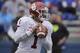 Oklahoma quarterback Jalen Hurts looks for a receiver during the second half of an NCAA college football game against Kansas, Saturday, Oct. 5, 2019, in Lawrence, Kan. (AP Photo/Charlie Riedel)