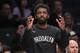 Brooklyn Nets guard Kyrie Irving reacts from the bench during the first half of an exhibition NBA basketball game against the Sesi/Franca Basketball Club, Friday, Oct. 4, 2019, in New York. (AP Photo/Mary Altaffer)