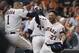 Houston Astros second baseman Jose Altuve (27) celebrates his solo home run against the Tampa Bay Rays with Carlos Correa (1) during the eighth inning of Game 5 of a baseball American League Division Series in Houston, Thursday, Oct. 10, 2019. (AP Photo/Eric Christian Smith)