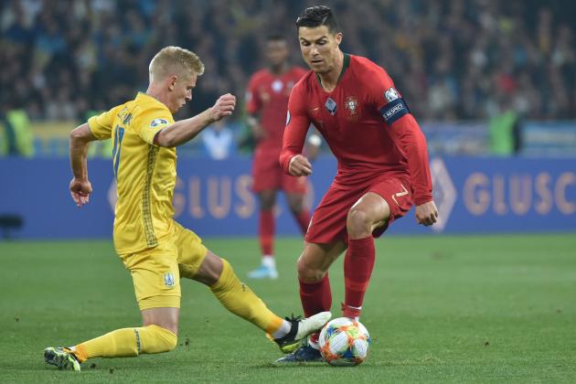 Ukraine's midfielder Oleksandr Zinchenko and Portugal's forward Cristiano Ronaldo vie for the ball during the Euro 2020 football qualification match between Ukraine and Portugal at the NSK Olimpiyskyi stadium in Kiev on October 14, 2019. (Photo by Genya SAVILOV / AFP) (Photo by GENYA SAVILOV/AFP via Getty Images)
