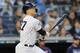 NEW YORK, NEW YORK - OCTOBER 05: Giancarlo Stanton #27 of the New York Yankees hits a sacrifice fly to score Aaron Judge #99 in the third inning of game two of the American League Division Series at Yankee Stadium on October 05, 2019 in New York City. (Photo by Elsa/Getty Images)