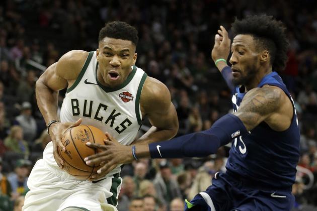 Milwaukee Bucks' Giannis Antetokounmpo, left, drives to the basket against Minnesota Timberwolves' Robert Covington during the first half of a preseason NBA basketball game Thursday, Oct. 17, 2019, in Milwaukee. (AP Photo/Aaron Gash)