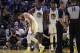 Golden State Warriors' Stephen Curry, left, grimaces after Phoenix Suns' Aron Baynes fell onto him during the second half of an NBA basketball game Wednesday, Oct. 30, 2019, in San Francisco. Curry left the game. (AP Photo/Ben Margot)