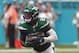 FILE - In this Sunday, Nov. 3, 2019, file photo, New York Jets running back Le'Veon Bell (26) runs during the second half of an NFL football game against the Miami Dolphins, in Miami Gardens, Fla. Bell had an MRI on one of his knees, and the Jets are awaiting the results to see if the star running back will need to miss any time. Coach Adam Gase says Monday, he's unsure when Bell was injured during New York's 26-18 loss at Miami on Sunday. Gase learned of it Monday morning when Bell had to miss team meetings to undergo the tests.(AP Photo/Wilfredo Lee, File)